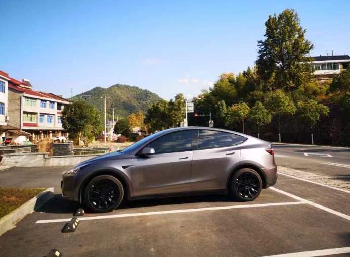 Gray electric car parked in a residential area in Zhejiang Province, China.